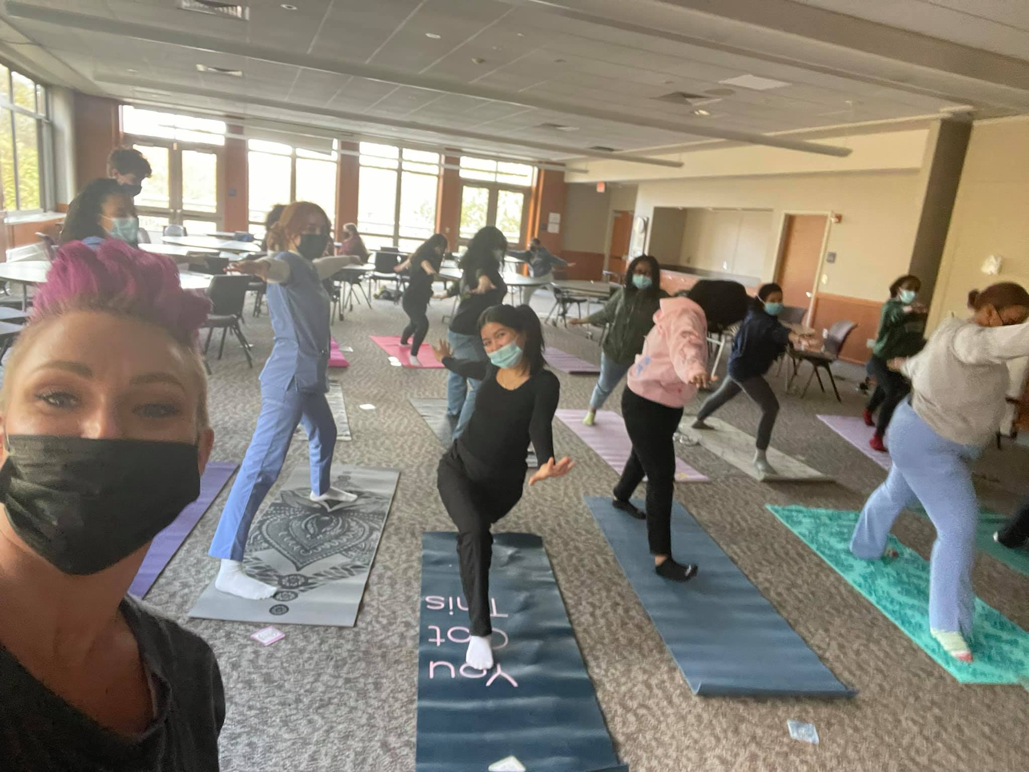 Founder of FITCLUB Foundation taking selfie with High School students doing yoga